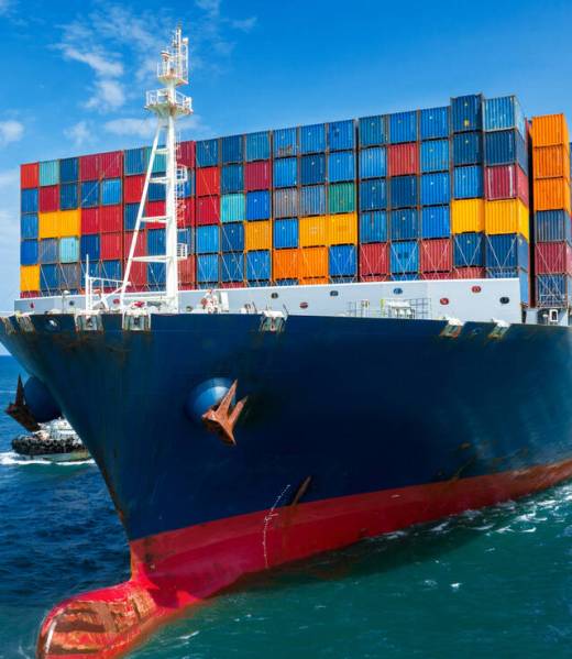 In Front View of large cargo ship import export container box on In Front View of large cargo ship import export container box on the ocean sea on blue sky back ground concept transportation logistic and service to customer and supply change forwarder mast